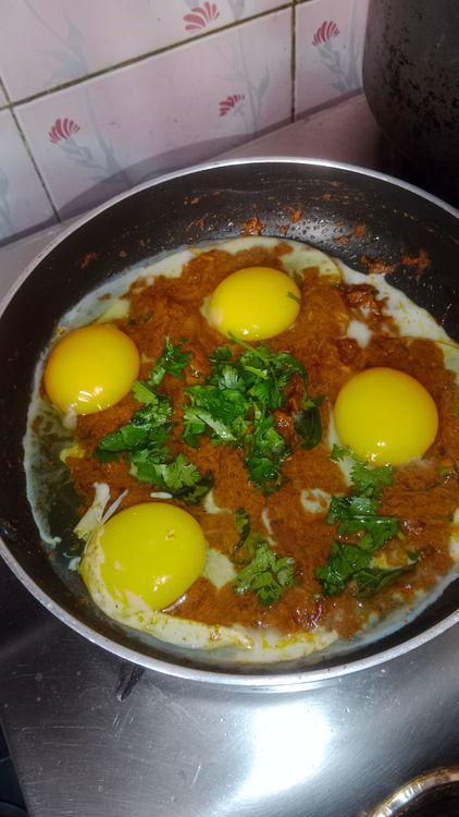 Step 2.1: Lower the flame and crack eggs into the pan