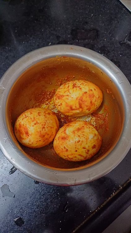 Step 1.1: Make small cuts on the boiled eggs and marinate them with red chilli powder, turmeric powder, black pepper powder, salt, and oil
