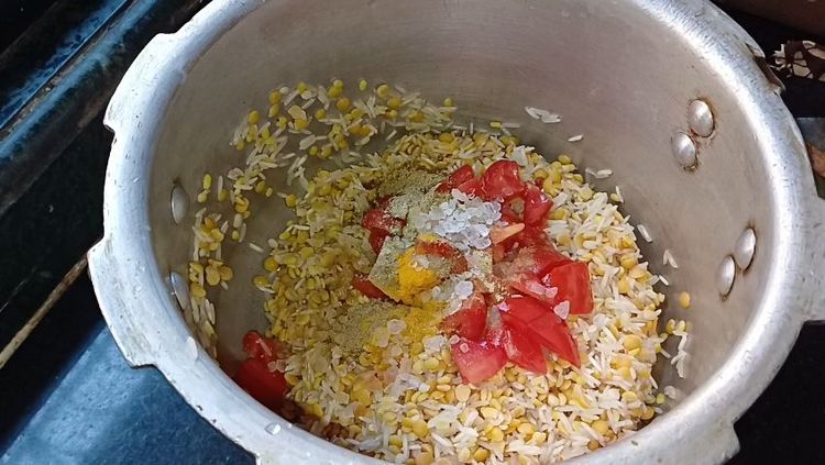 Step 1.1: Dice the tomato and add it to the cooker along with turmeric powder, coriander cumin powder, and rock salt
