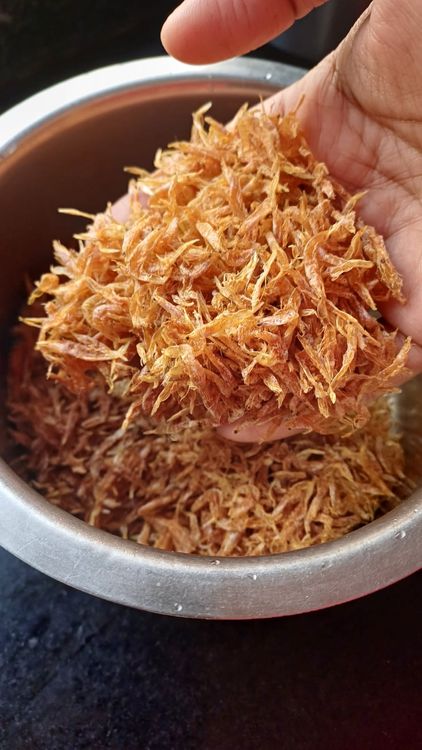 Step 1.1: To remove any sand, stones, or impurities,  rinse Sukha Jawla (dried tiny shrimp) with warm water