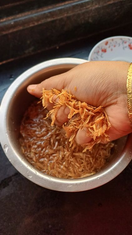 Step 1.2: To remove any sand, stones, or impurities,  rinse Sukha Jawla (dried tiny shrimp) with warm water