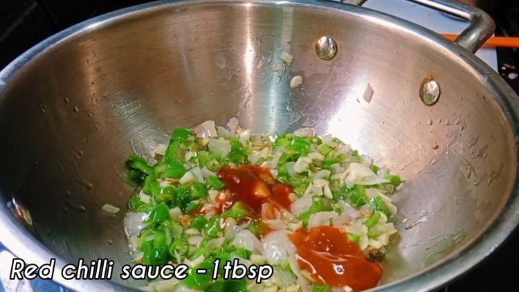 Step 3.1: In a wok, heat oil and add finely chopped onion, green capsicum, and a pinch of salt