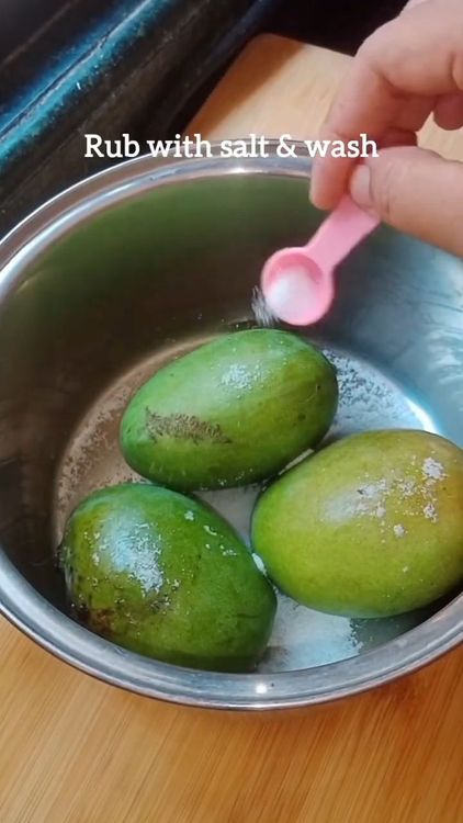 Step 1.1: Clean the skin of the raw mangoes with salt to remove chemical impurities, if present