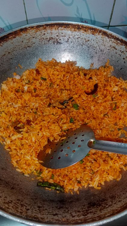 Step 3.1: Add the seasoned rice to the pan with the tempering and mix well