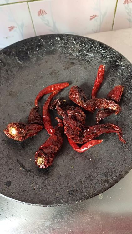 Step 2.1: Dry roast guntur dry red chillies and kashmiri dry red chillies until they puff