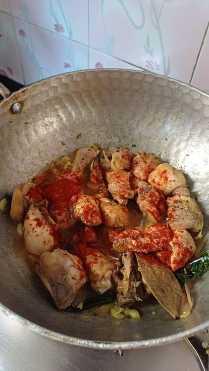 Step 3.1: Add the salted chicken pieces, turmeric powder, and red chilli powder