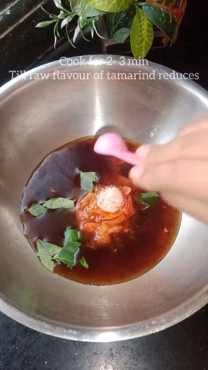 Step 1.1: Heat a pan and add tamarind water, curry leaves, crushed tomato, tomato puree, turmeric powder, and salt