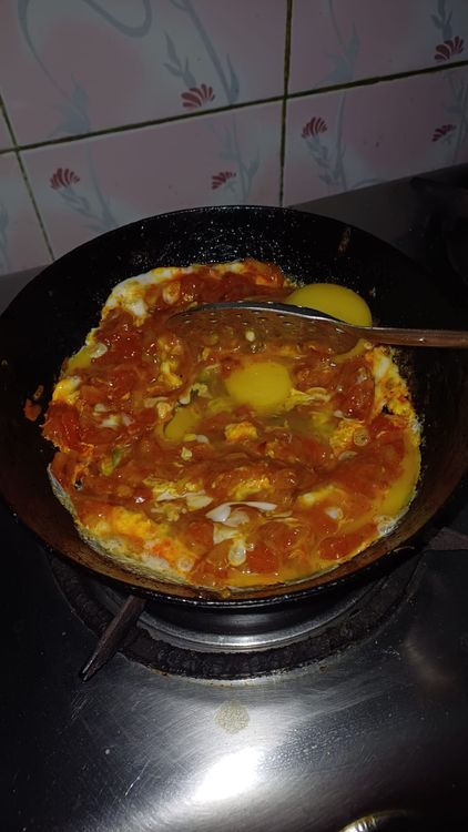 Step 1.2: Crack the eggs into the pan and mix gently