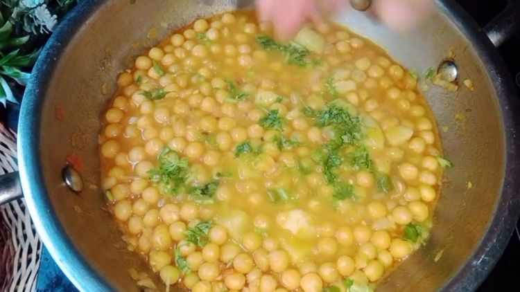 Step 2.1: Add the cooked peas, 1 tbsp bhaja masala, and coriander leaves