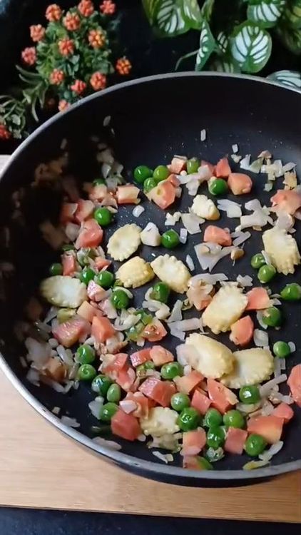 Step 1.2: Toss in finely chopped onion, sliced baby corn, diced carrot, and green peas
