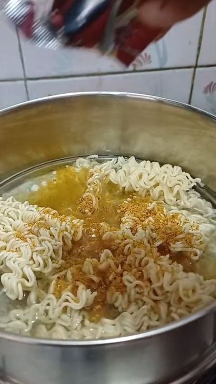Step 1.1: Empty the Maggi packet into the pan, including the noodles and masala mix