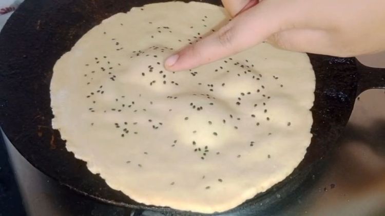 Step 1.1: Cook until bubbles appear and the roti sticks to the tawa