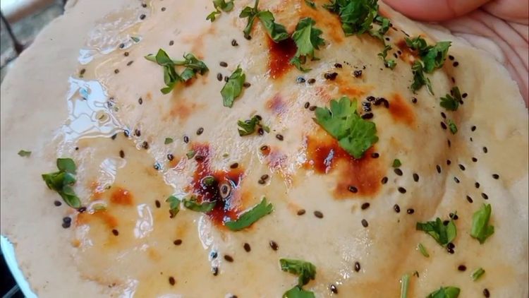 Step 1.3: Brush the cooked roti with butter or ghee and garnish with coriander leaves before serving