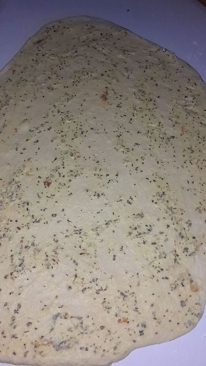 Step 5.1: Coat the flat dough evenly with the garlic butter mixture and roll up