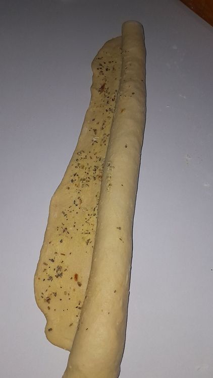Step 5.2: Coat the flat dough evenly with the garlic butter mixture and roll up