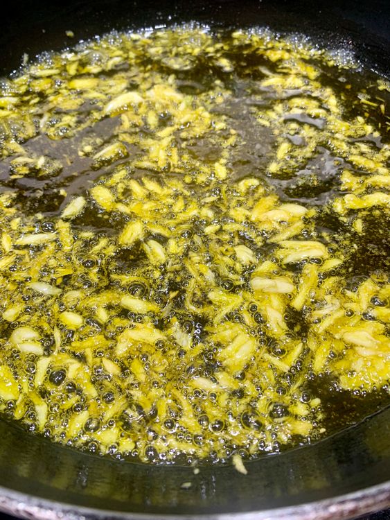 Step 1.2: Reheat the oil on low-medium heat, add asafoetida and the crushed garlic, and saute for 2-3 minutes until slightly golden