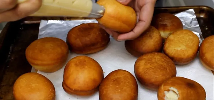 Step 3.1: Allow donuts to cool completely, then make a hole in each donut and pipe the custard into the hole