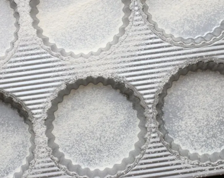Step 1.1: Lightly sprinkle flour into the bottom of tart pans to prevent sticking