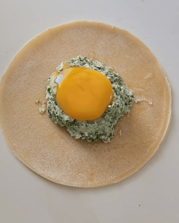 Step 4.1: Create a small well in the middle of the filling and carefully add an egg yolk into the center