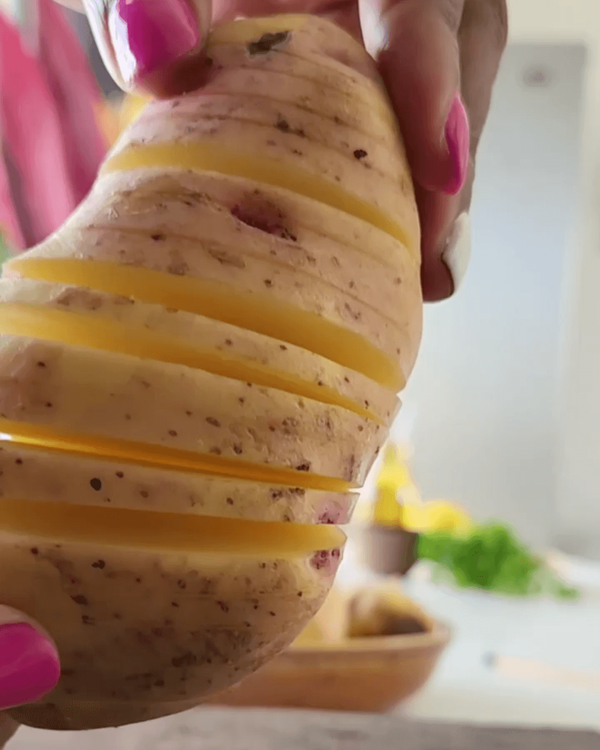 Step 1.1: Slice potatoes widthwise, stopping half an inch before the end