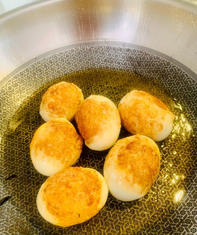 Step 1.1: In the same pan, add the boiled eggs and stir-fry them until golden brown