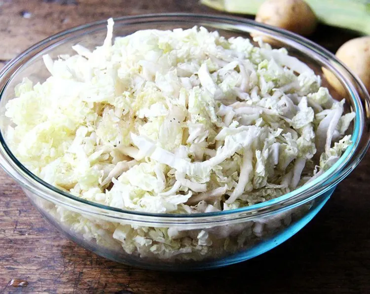 Step 1.1: Place shredded green cabbage in a large bowl