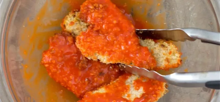 Step 1.1: In a medium bowl, add buffalo sauce and chicken tenders, and toss with tongs until fully coated