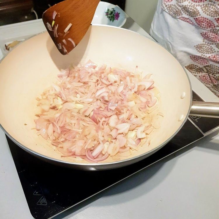 Step 2.2: Heat coconut oil in a pan and sauté the sliced onions on medium heat until golden brown