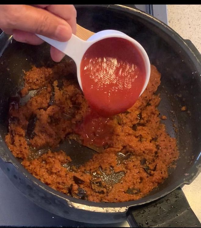 Step 1.2: Stir in the kashmiri red chilli powder and tomatoes to the mixture