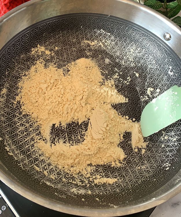 Step 3.1: Dry roast gram flour (besan) in a heavy-bottomed deep pan over low-medium heat until it turns aromatic and slightly golden