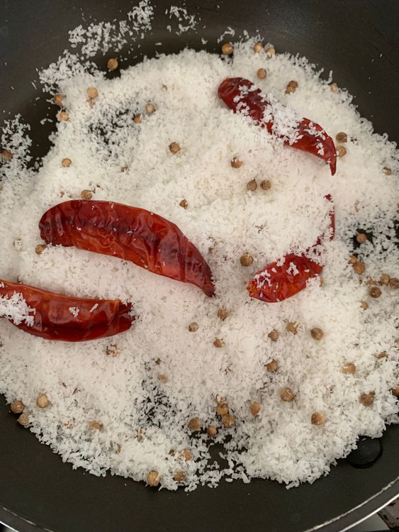 Step 1.1: Dry roast the desiccated coconut, dry red chillies, and coriander seeds until they turn slightly brown