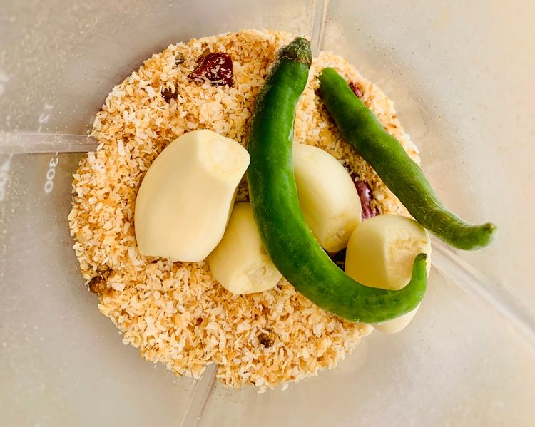 Step 1.1: Grind the roasted coconut mixture with garlic cloves and green chillies to form a paste