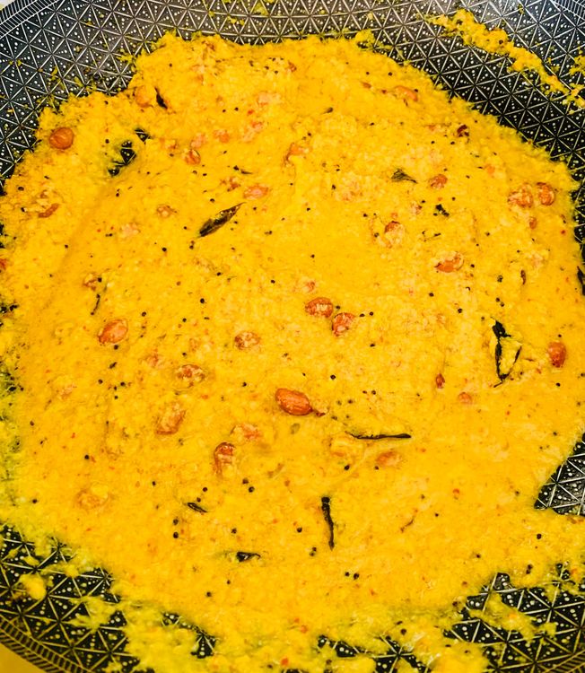 Step 1.2: Add the coconut paste, turmeric, and salt to the wok, mix well and cook for 3-4 minutes