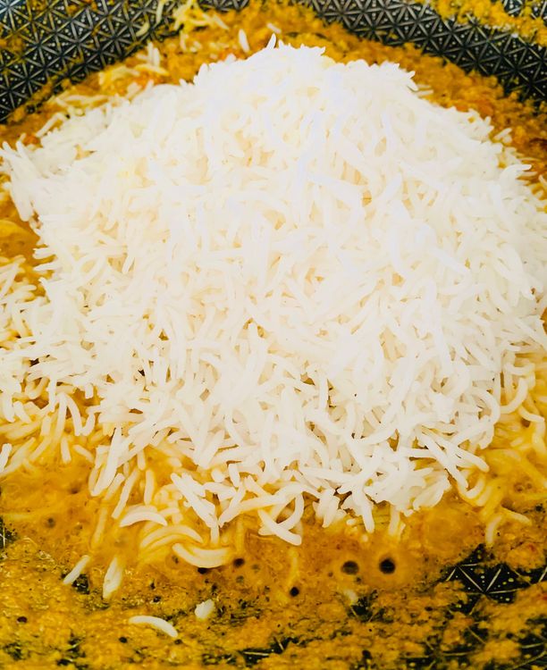 Step 1.1: Add the boiled rice, mix well, turn off the heat, and let it sit covered for a few minutes