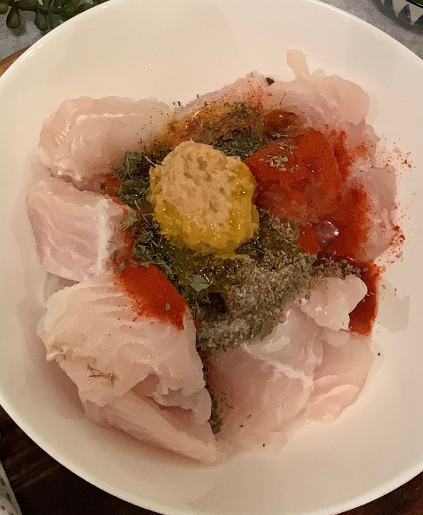 Step 2.1: Marinate the fish by adding lemon juice, red chilli powder, salt, carom seeds, asafoetida, ginger garlic paste, dry fenugreek leaves and mustard oil