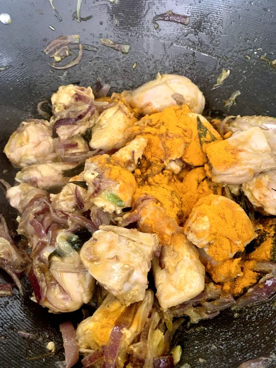Step 1.1: Stir in turmeric powder, red chilli powder, and the ground Kashmiri chilli paste