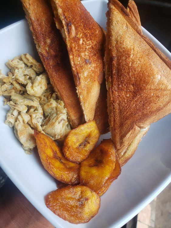 Step 1.4: Using a frying spoon, place the plantain in the oil and let it fry for about a minute or until it turns golden brown
