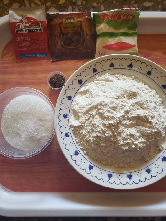 Step 1.1: Add flour, sugar, nutmeg, instant yeast, milk flavour, pepper and salt to a bowl and mix thoroughly till even