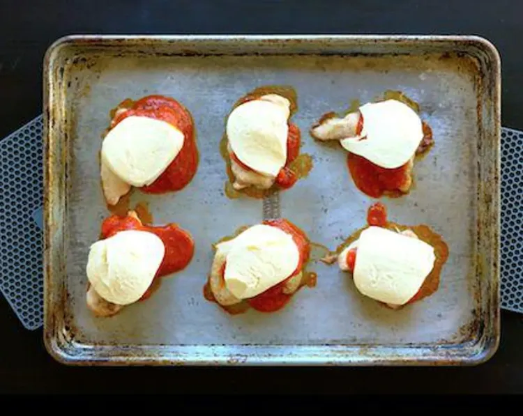 Step 2.1: Pour half the marinara sauce over the chicken thighs