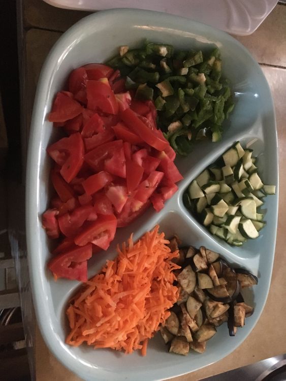 Step 1.1: Chop the onion, tomato, green pepper, and courgette into bite-sized pieces