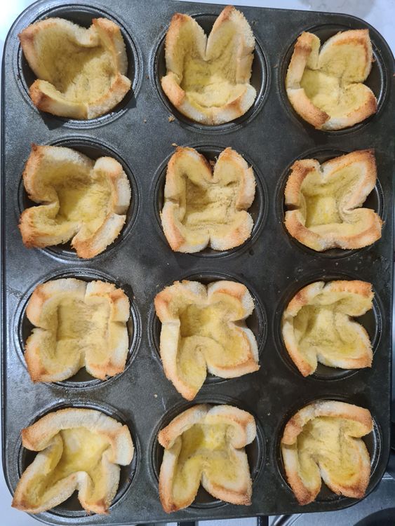 Step 1.1: Apply margarine on both side and place the slice in the muffin tray to create little basket