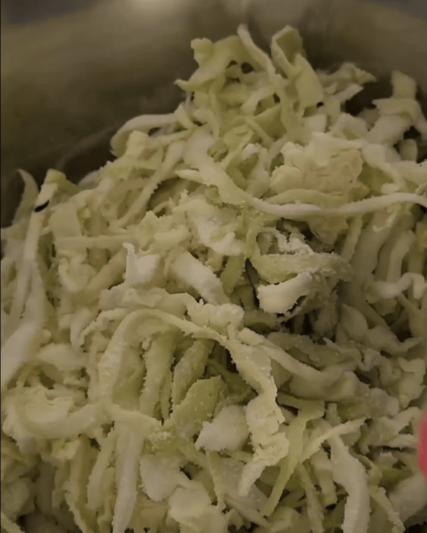 Step 1.1: Place the chopped cabbage in a large bowl and add salt, tossing to coat evenly