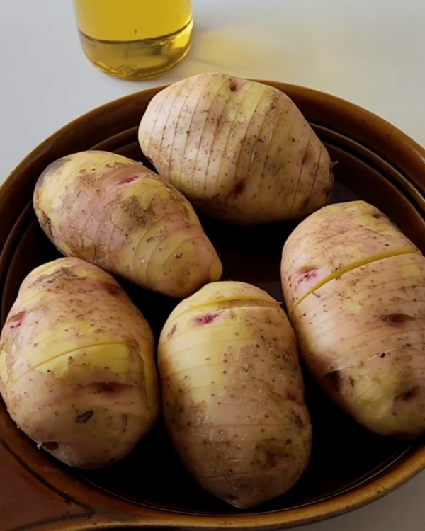 Step 1.2: Slice potatoes widthwise, stopping half an inch before the end