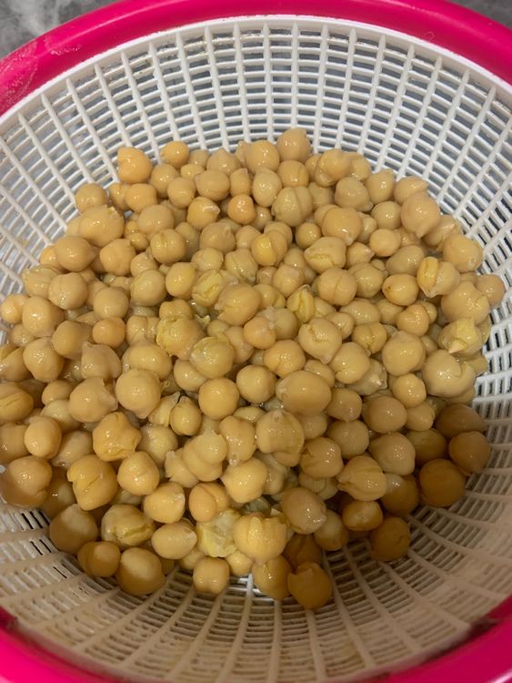 Step 1.1: Once the pressure is released, open the lid of the pressure cooker and drain the water from the boiled chickpeas