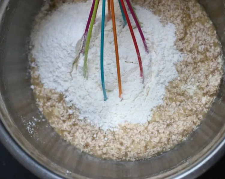 Step 1.1: Add half of the flour mixture at a time to your wet ingredients, whisking or stirring by hand, just until combined
