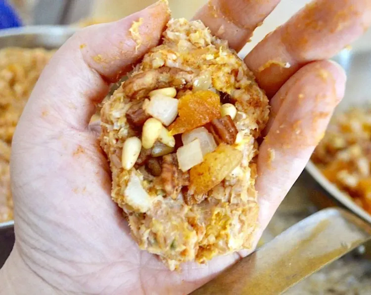 Step 4.1: Take a big handful of the chicken mixture about the size of your palm and make a big indentation in the middle