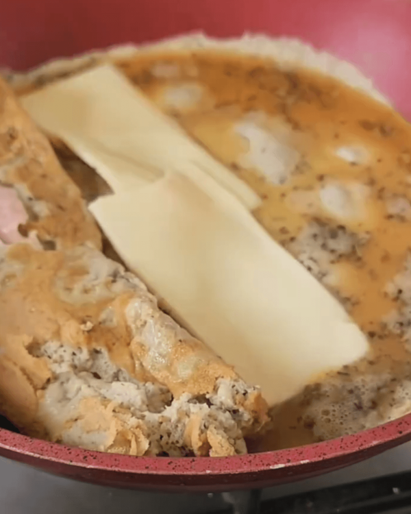 Step 2.1: Pour the remaining egg mixture into the empty side of the skillet, allowing it to spread and cook slightly