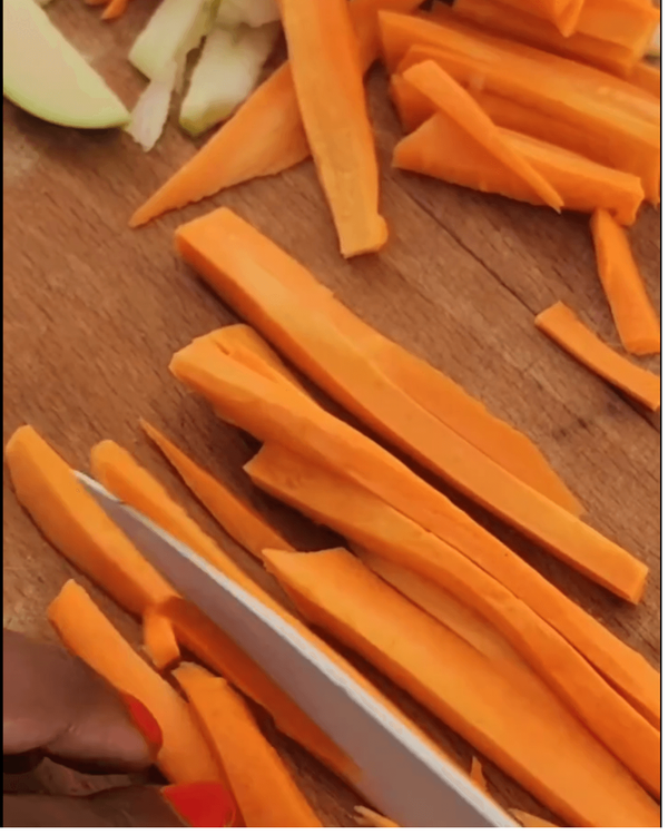 Step 2.1: Transfer the cabbage to a large bowl and add the sliced apple, julienned carrot, and chopped spring onions