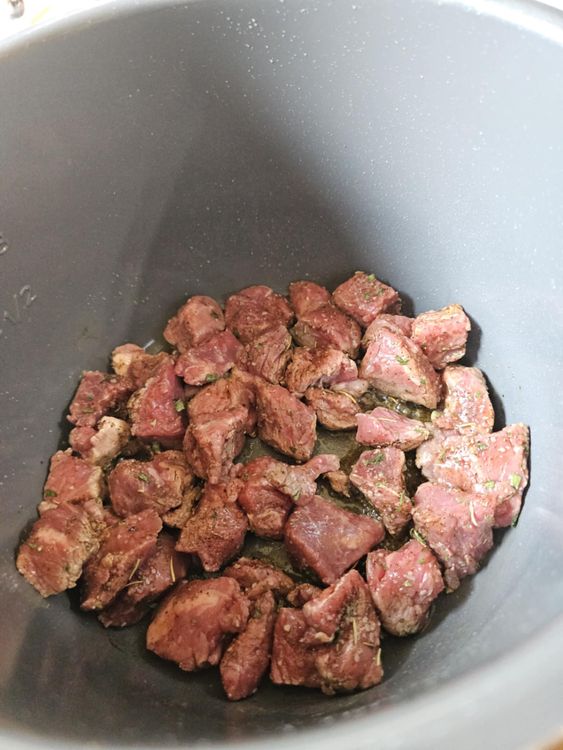 Step 1.1: When the oil is hot, add the stew meat in a single layer and season with a little of the stew seasoning mix