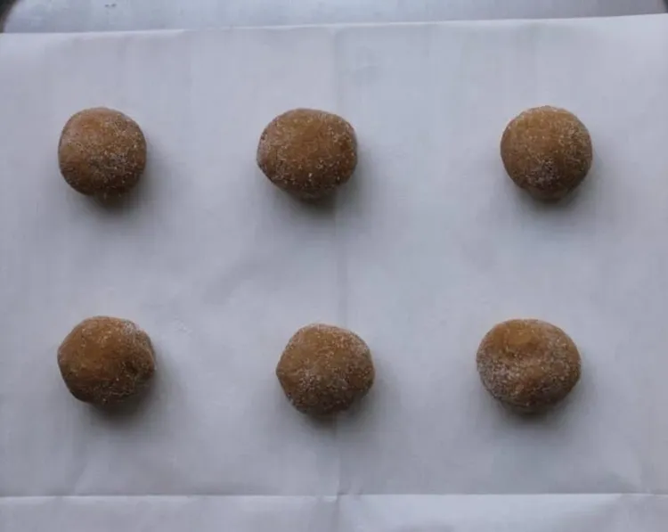 Step 6.1: Place balls about 2-1/2 inches apart on an ungreased cookie sheet lined with parchment paper